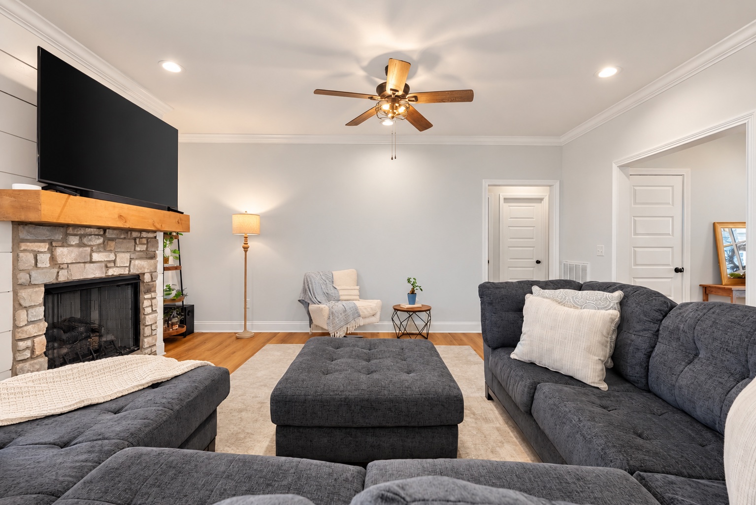 Living room at 23 Cornerstone Dr centered on the stone gas-log fireplace