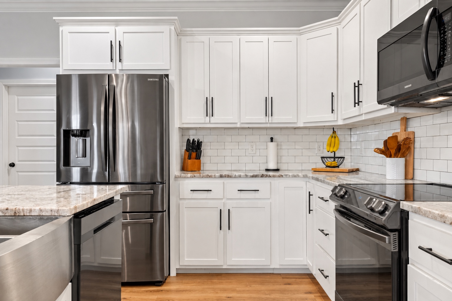 Stainless kitchen appliances, subway tile backsplash and white cabinetry at 23 Cornerstone Dr