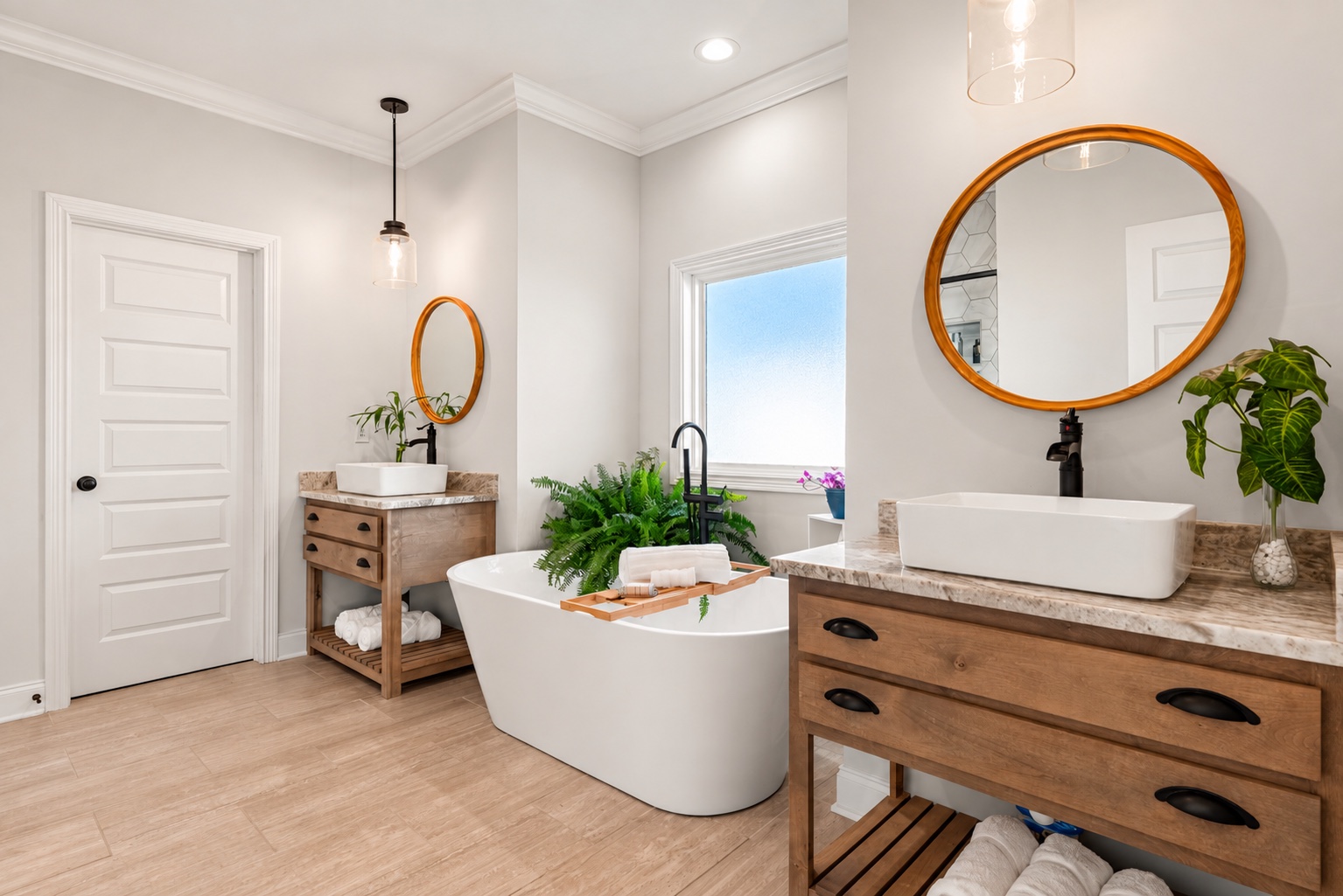 Angled view of the two vanities and freestanding tub in the primary bathroom at 23 Cornerstone Dr