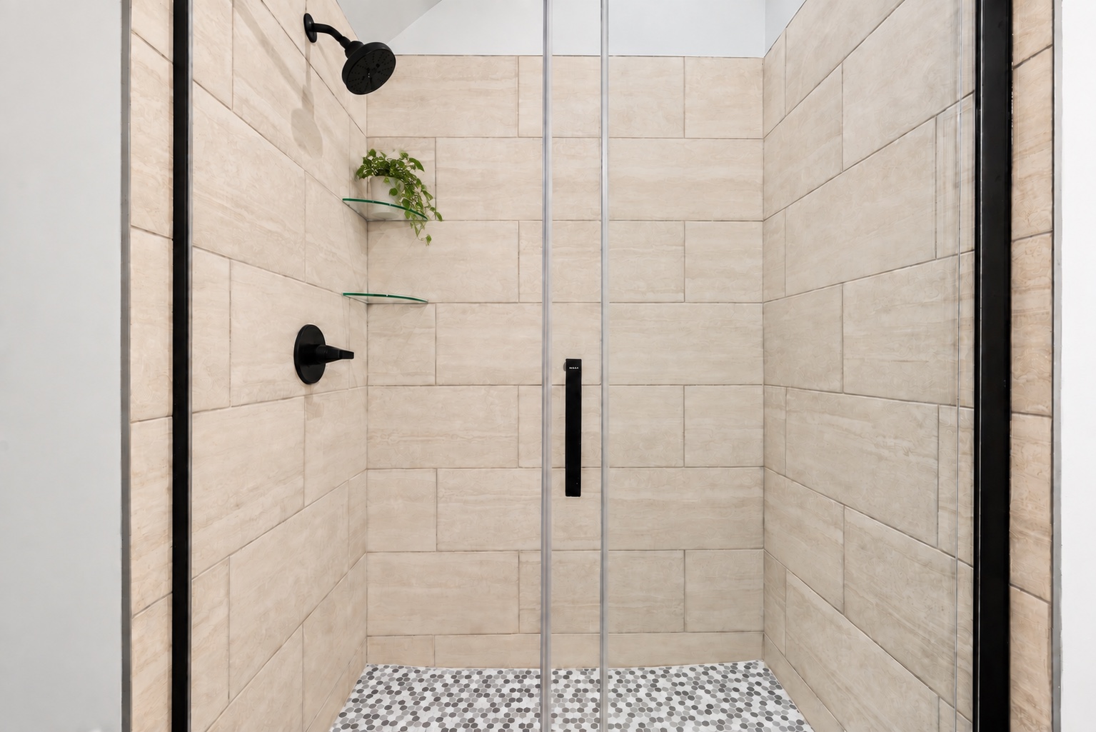Tiled shower with glass enclosure in a bathroom at 23 Cornerstone Dr