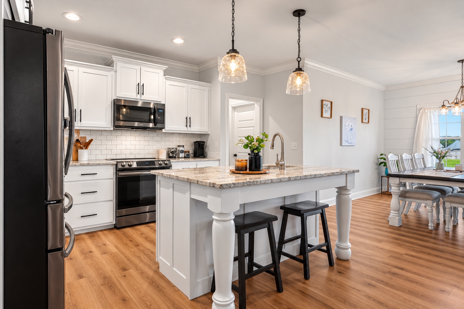 Kitchen and dining area at 23 Cornerstone Dr with granite island and white cabinetry