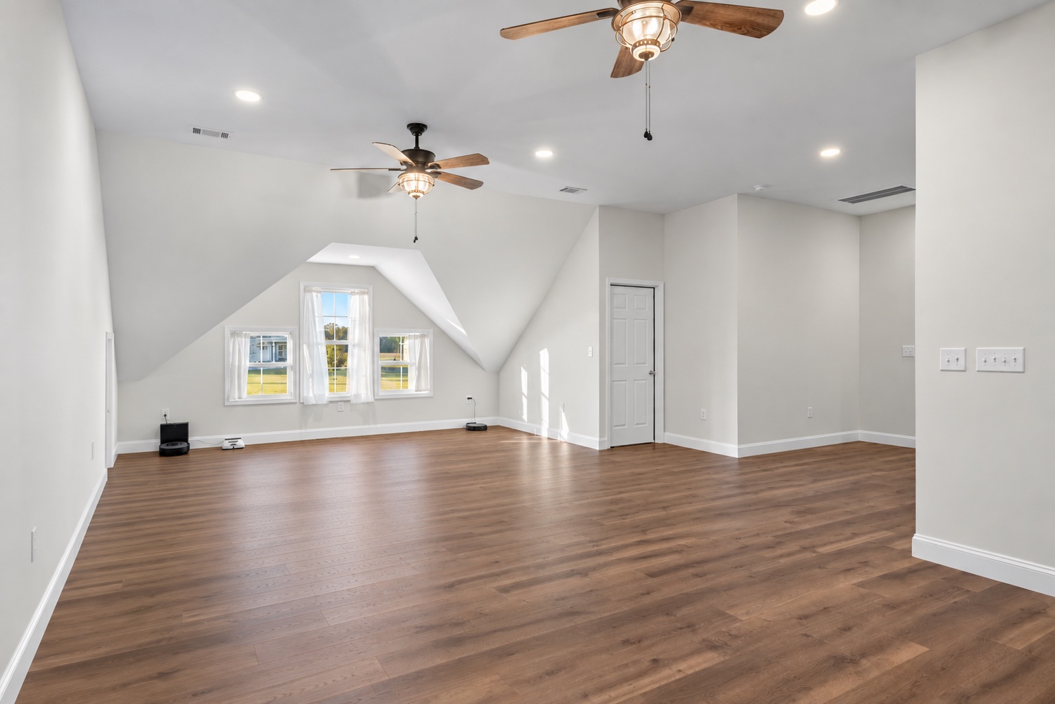 Angled view of the unfurnished bonus room on the finished upper level at 23 Cornerstone Dr