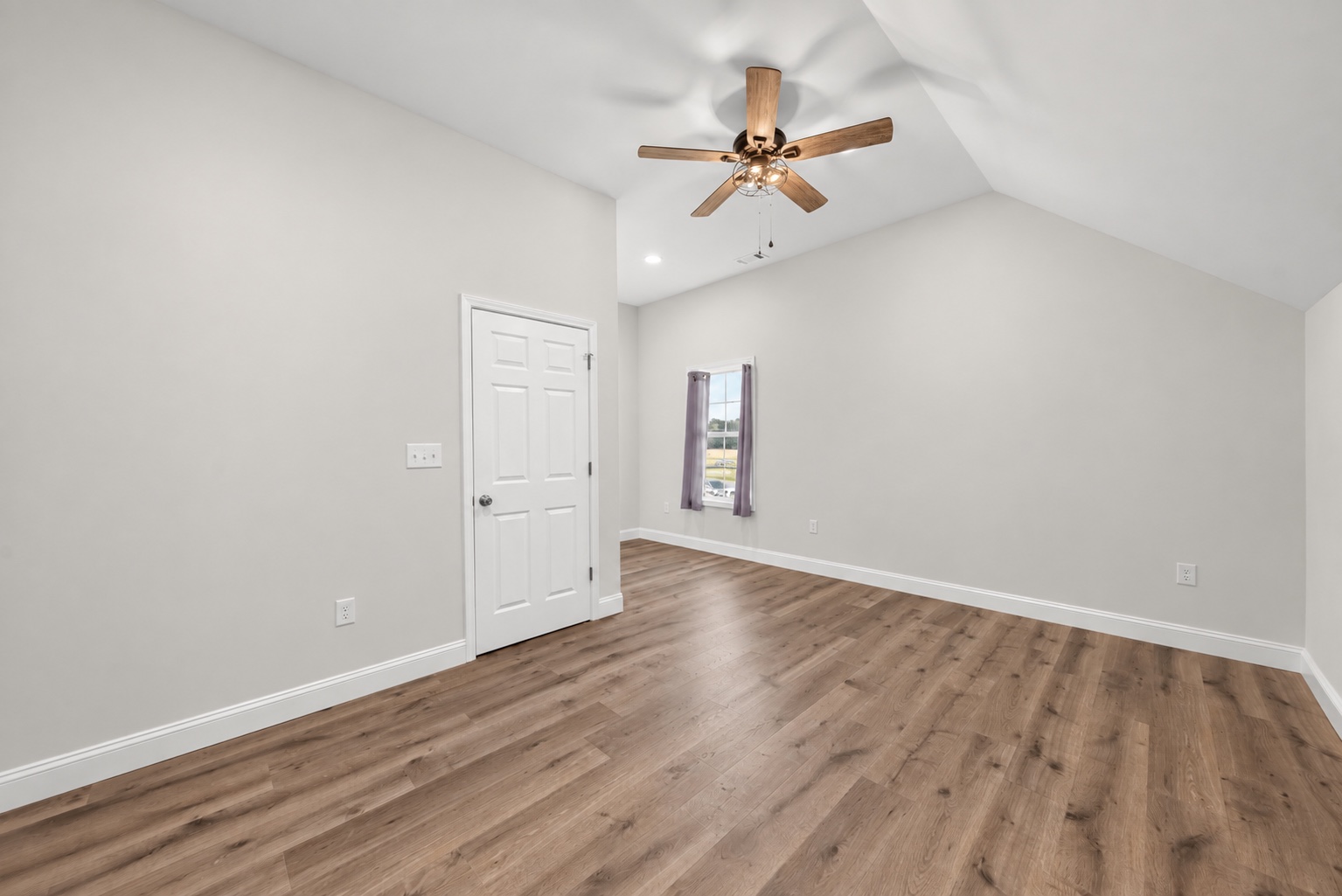 Unfurnished bedroom at 23 Cornerstone Dr with wood flooring and a vaulted ceiling
